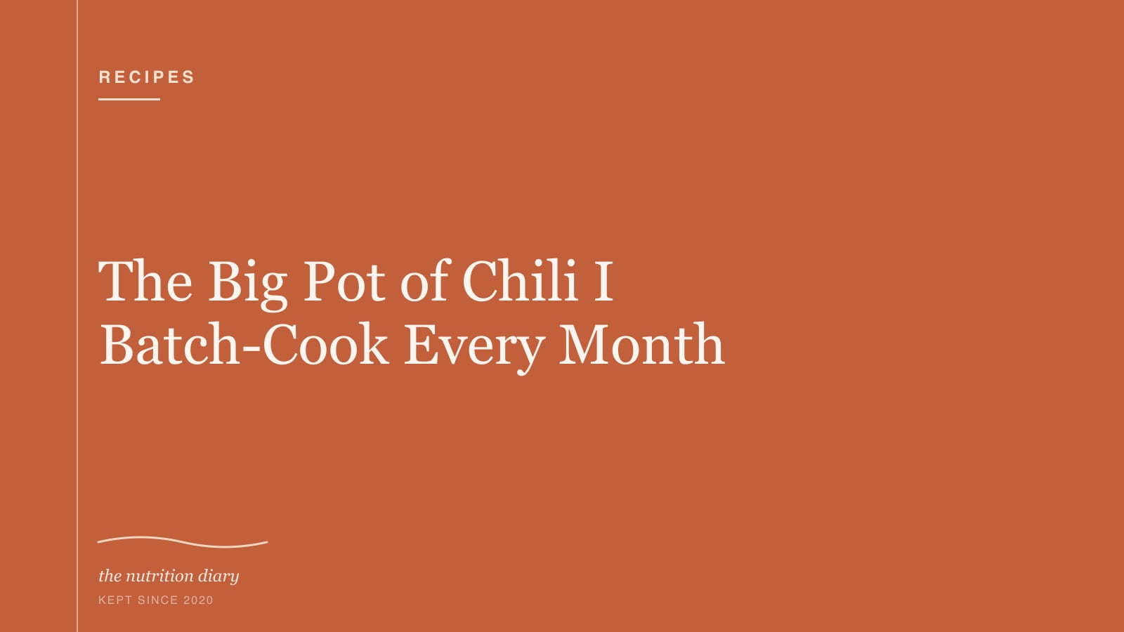A large pot of dark red chili with beans, topped with cilantro and a wooden spoon