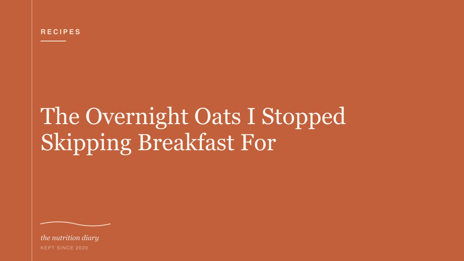 A glass jar of overnight oats topped with berries and a spoon resting beside it